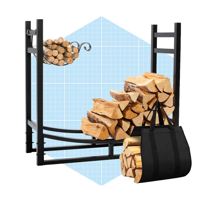 A log holder displays stacked firewood, with a smaller bundle hanging above, against a light blue grid background. A black carrying bag rests beside the logs.