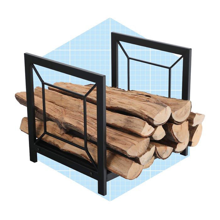 A stack of firewood is neatly arranged in a black metal holder, set against a blue geometric background.