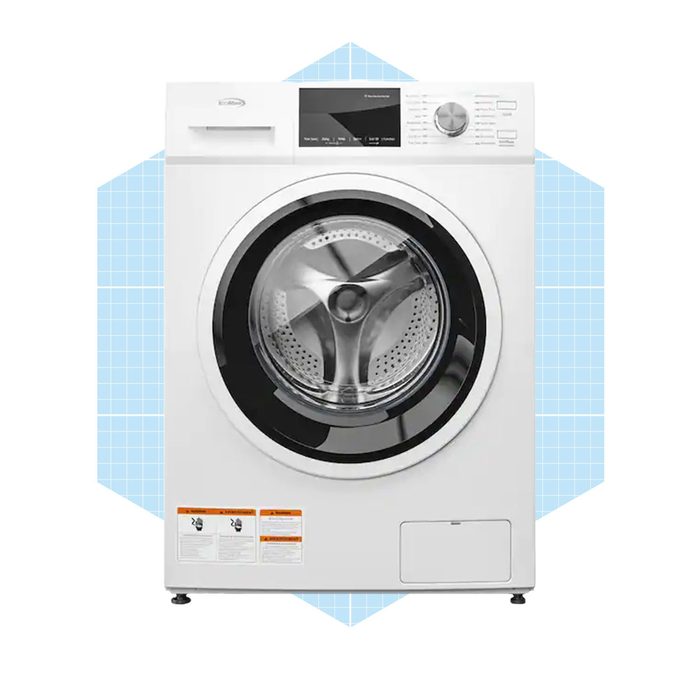 A front-loading washing machine stands still, showcasing a clear drum and control panel, set against a light blue geometric background.
