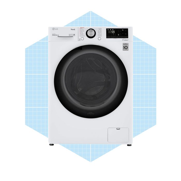 A white front-loading washing machine displays settings and a timer on a light blue geometric background, indicating it is ready for operation.