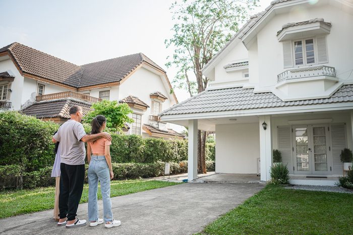 family in front garden of house